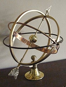 A Vesta armillary in the non patinated natural brass and copper bronze finish.