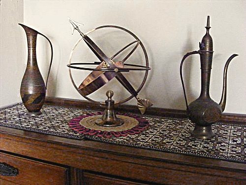 A Vesta armillary on display indoors as a focal point in a room.