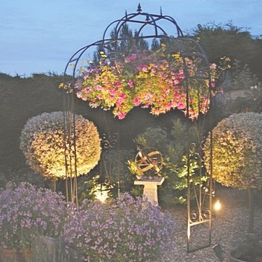 A Mandala armillary at night, lit as the centrepiece of an illuminated display.