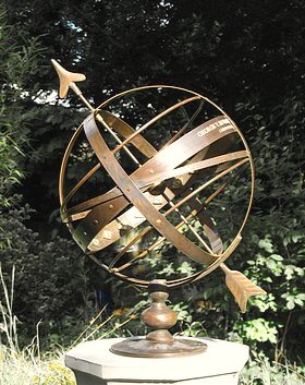 A close view of an Orbis armillary with a personal inscription engraved along the equatorial band.