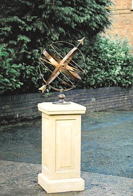 An Orbis armillary on a plain panelled Tuscan plinth standing in front of a brick wall.