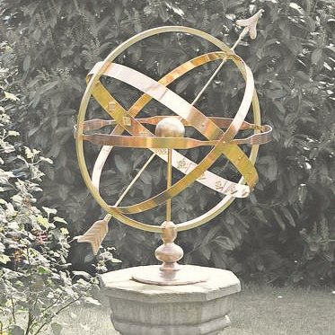 The all-bronze Solstice armillary, its colures and equatorial band of mounted Roman numerals arranged around a central orb.