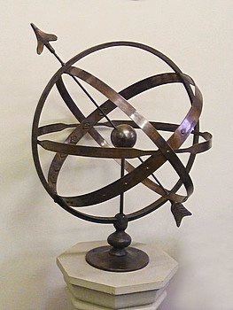 A 20 inch bronze Solstice armillary standing on display.
