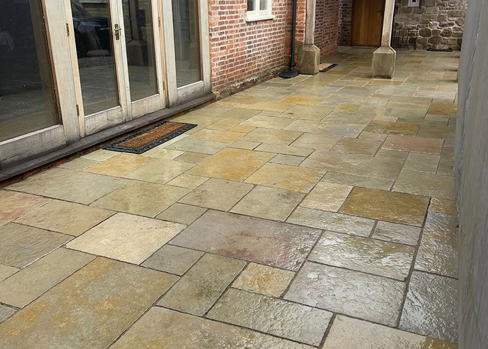 Mossy garden path restored to warm sandstone in Shropshire, after