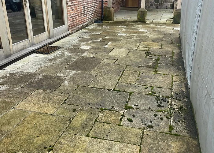 Mossy garden path restored to warm sandstone in Shropshire, before