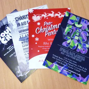 A fan of printed A4 event flyers for local charity nights, Christmas parties and a music festival.