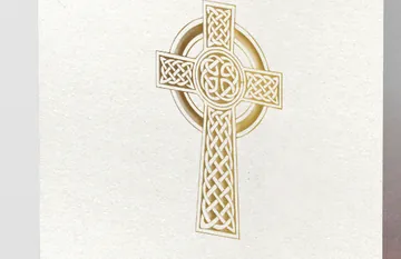 A printed order of service cover, a gold Celtic cross foiled onto textured cream stock.