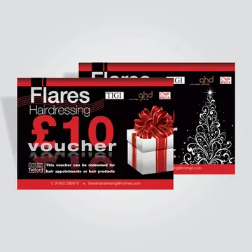 Two printed cards in black and red, the front one a Flares Hairdressing gift voucher with an illustrated white present tied in red ribbon, the card behind it showing a white swirling tree design on black.
