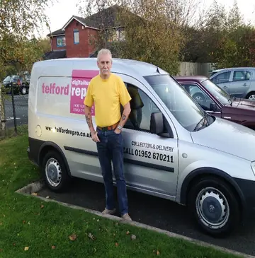 A Telford Repro branded van with collection and delivery lettering and the phone number 01952 670211, a man in a yellow shirt standing beside it.