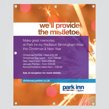 An outdoor PVC banner printed for Park Inn by Radisson Birmingham West, reading we'll provide the mistletoe over a photograph of sparklers, with a metal eyelet punched into each corner and along the edges.