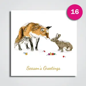A square Christmas card with a watercolour fox nose to nose with a hare among a few scattered baubles, and Season's Greetings in gold script.