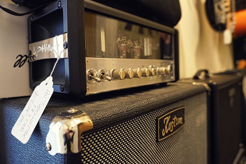A used Hughes and Kettner valve amp head on a Kustom cabinet with a handwritten price tag