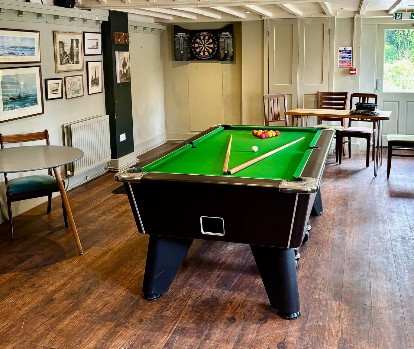 The games room at The Water Rat with a pool table and beamed ceiling