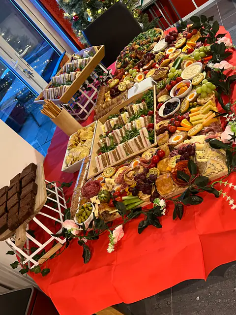 Finger sandwiches, scones and strawberry desserts on an afternoon tea table