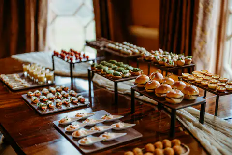 Tiered canapé stands set out along a polished table in a Midlands function room