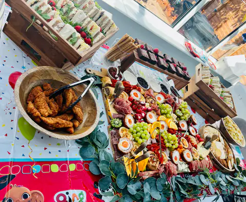 A birthday grazing table with chicken goujons, scotch eggs, grapes and cured meats