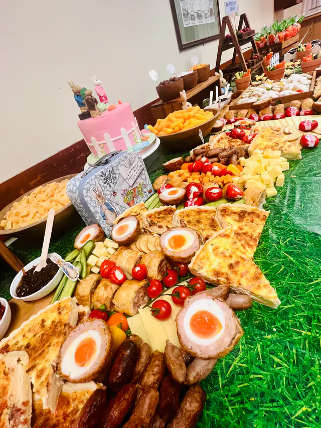 A garden party graze table with scotch eggs, cheese, chutney and fresh fruit
