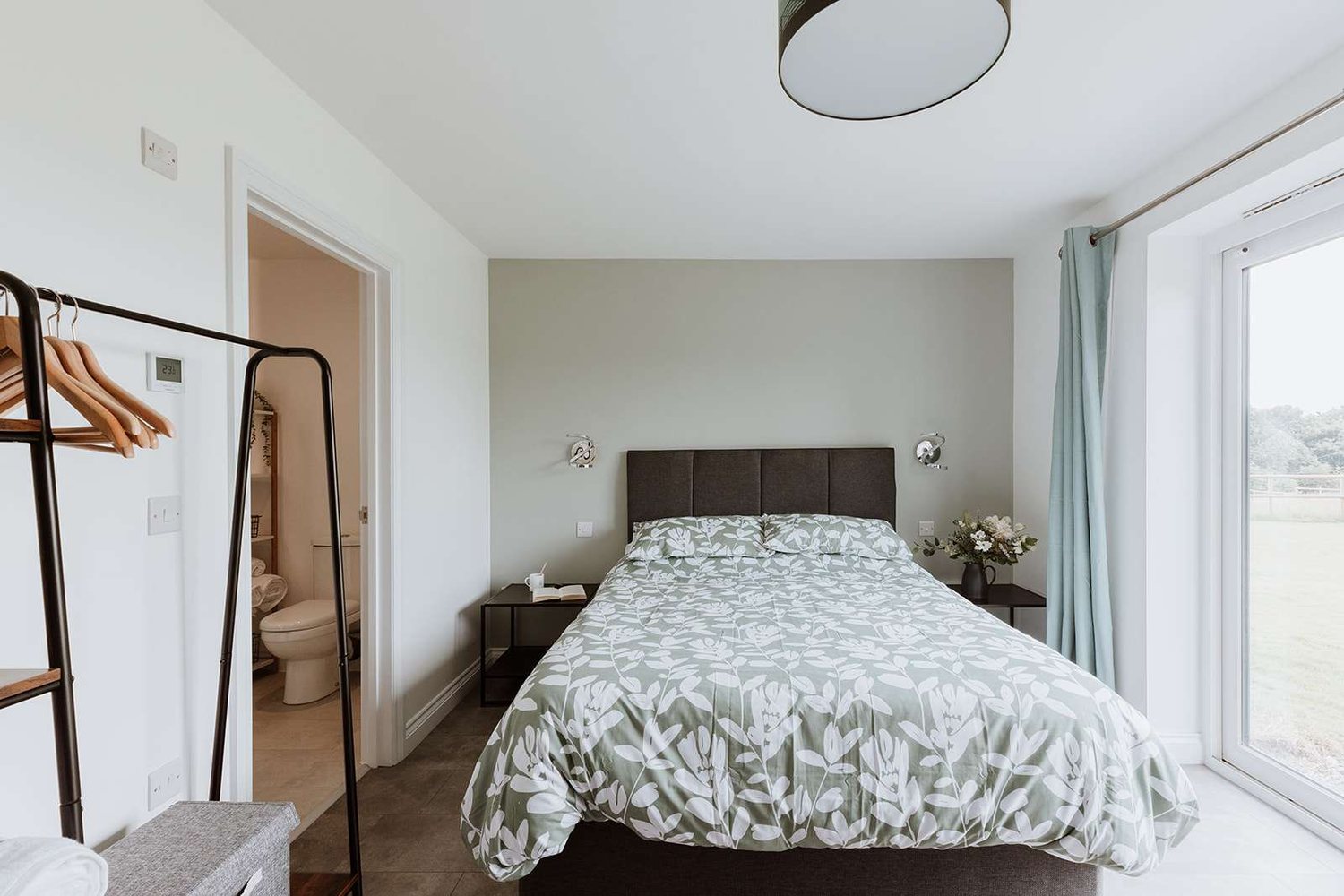 The Gorge Room at The Woodlands, with sage-green walls and botanical linen